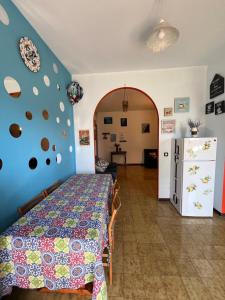 a bedroom with a bed and a room with a refrigerator at Ambrazzurra Apartament in Aci Castello
