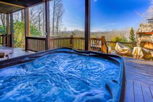 a hot tub on the deck of a house at Mountain Melody in Morganton