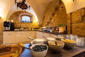 a kitchen with bowls of food on a wooden table at Apartment in Papstdorf "Häntzschelstiege" in Kurort Gohrisch