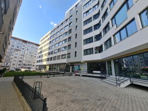 a large building with a courtyard in front of it at Nordic Residence 23 in Suceava