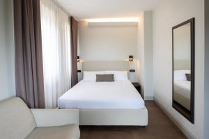 Letto o letti in una camera di Hotel Carlton