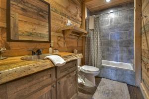 a bathroom with a sink and a toilet at Skys The Limit - Blue Ridge Cabin - Pet Friendly in Mineral Bluff +51 photos