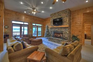 a living room with couches and a fireplace at When in Rome - Luxury Lakeside Blue Ridge Cabin - Spacious Lakeside Luxury, Hot Tub, Game Room, Lake Dock, Steps To Lake Blue Ri in Blue Ridge