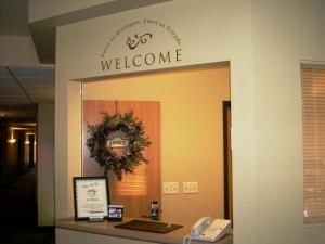 a welcome sign on a wall in a office at Sandhills Guest House Motel in Atkinson