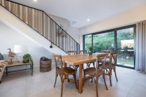 a dining room with a wooden table and chairs at Moyana 14 in Ballito