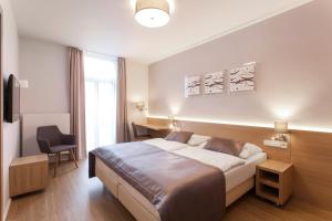 Postel nebo postele na pokoji v ubytování Hotel Carol