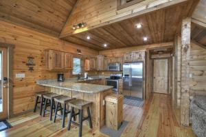 a kitchen with a large island in a log cabin at Altitude Adjustment - Blue Ridge - Mountain Views in Blue Ridge