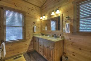 a log cabin bathroom with a sink and a mirror at Altitude Adjustment - Blue Ridge - Mountain Views in Blue Ridge +28 photos