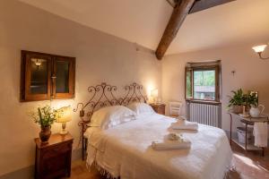 a bedroom with a bed with two towels on it at Casa nel Bosco in Arezzo