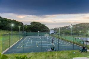 a tennis court with two people on it at Moyana 14 in Ballito