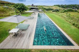 an overhead view of a swimming pool with tables and umbrellas at Moyana 14 in Ballito