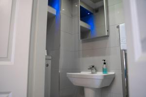 a white bathroom with a sink and a mirror at Perfectly located central Chester town house -2BR in Chester +21 photos