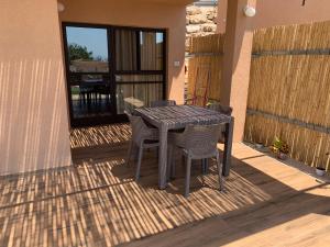 a black table and chairs on a patio at Emanuela Chalets in Moshav Ramot
