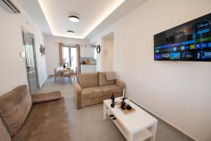 a living room with a couch and a table at Sophie's Apartments 5 & 6 in Poros