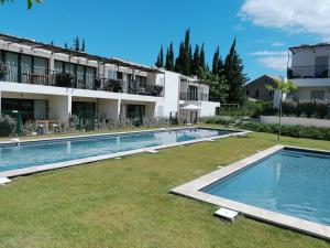 a large swimming pool in front of a building at A GAUGUIN Cyclistes Ventoux in Malaucène