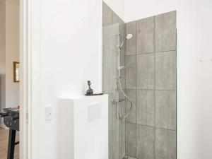 a bathroom with a shower with a glass door at 8 person holiday home in Rømø-By Traum in Kongsmark +32 photos