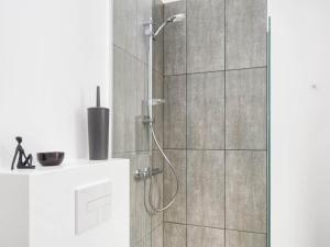 a shower with a glass door in a bathroom at 8 person holiday home in Rømø in Kongsmark +30 photos