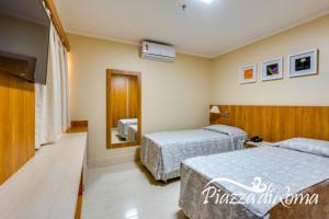 Cama ou camas em um quarto em diRoma Piazza direto com o Grupo diRoma com acesso ao Acqua Park e Café da manhã
