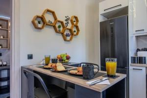 a kitchen with a table with food and drinks on it at Envy Luxury Suite in Agia Pelagia