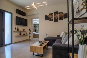 a living room with a couch and a coffee table at Envy Luxury Suite in Agia Pelagia