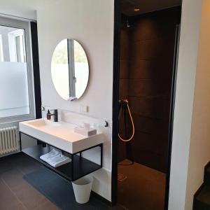a bathroom with a sink and a mirror at Bischoffs Hotel in Bad Urach