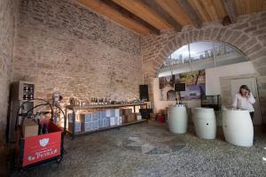 a woman talking on a cell phone in a wine tasting room at Seigneurie de Peyrat in Pézenas