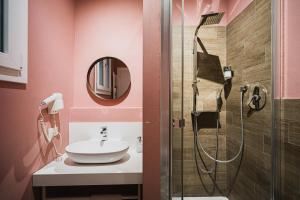 a bathroom with a sink and a shower at TORTE & LINI in Bologna