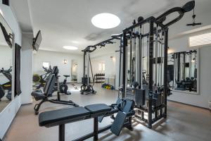 a gym with treadmills and elliptical machines at Mangia's Pollina Resort in Cefalù