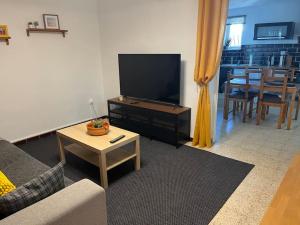 a living room with a flat screen tv and a table at New Appartement RDC de Villa 60 m2 proche plage in La Ciotat