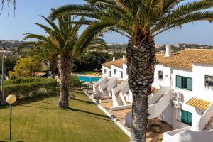 a view of the yard of a villa with palm trees at Parque Monte Verde in Albufeira