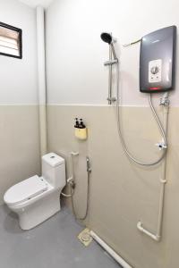 a bathroom with a shower and a toilet at Cozy Muji Studio Homestay near Taiping Lake Garden in Taiping