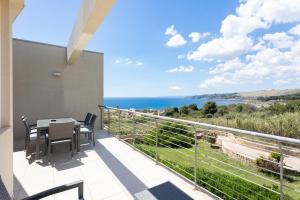 a balcony with a table and chairs and the ocean at 19 Summer Suites in Santa Cesarea Terme +44 photos