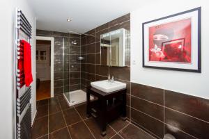 a bathroom with a sink and a mirror at Le Bartavel Apartment - Chamonix All Year in Chamonix-Mont-Blanc +18 photos