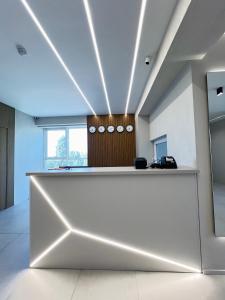 an office lobby with a large white reception desk at ALEM Hotel in Almaty