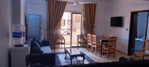 a living room with a couch and a table and chairs at شاليه قرية بلولاجون راس سدر - 3 غرف و2 حمام in Ras Sedr