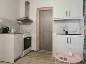 a small kitchen with a pink table in it at Casa Menidi in Menídion +8 photos