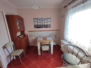 a small dining room with a table and chairs at Startpont Apartman in Pécs