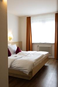 Postel nebo postele na pokoji v ubytování Hotel Kübler