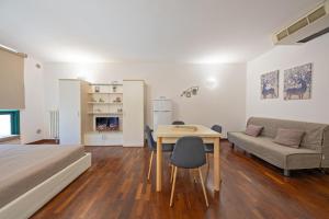a bedroom with a bed and a table and a couch at Interno 14 in Lecce