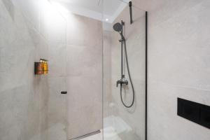 a shower with a glass door in a bathroom at Bob W Pärnu in Pärnu