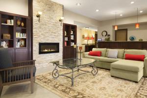 a living room with a couch and a fireplace at Country Inn & Suites by Radisson, Baltimore North, MD in White Marsh