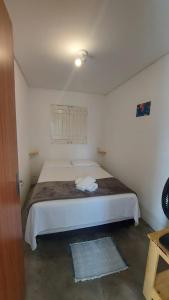 a bedroom with a large white bed in a room at Chalés Villa Carpe Diem in Bezerros