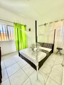 Postel nebo postele na pokoji v ubytování Guesthouse Cocotiers Cotonou