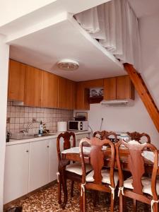a kitchen with a table and chairs and a sink at Amersa's House in Skiros