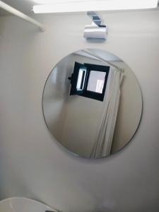 a mirror on a wall with a window in it at Amersa's House in Skiros +29 photos