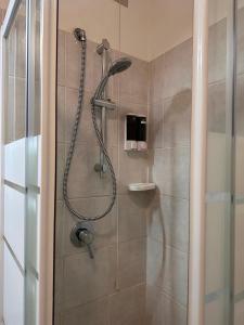 a shower with a shower head in a bathroom at Il Mulino Bilocale in centro in Ponte di Legno