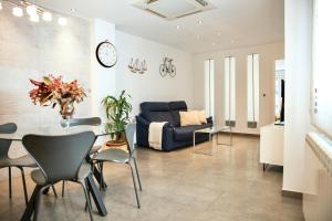 a living room with a table and a blue couch at LC Las Armas in Zaragoza