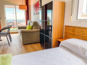 a bedroom with a bed and a couch at Attic by Unik Vacation in Tarragona