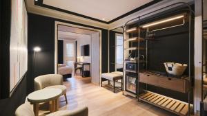 a living room with black walls and a table and chairs at ESTIMAR Valencia in Valencia +44 photos