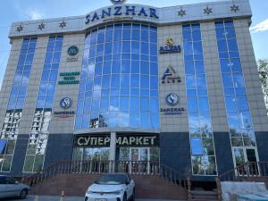 a car parked in front of a car market at ALEM Hotel in Almaty